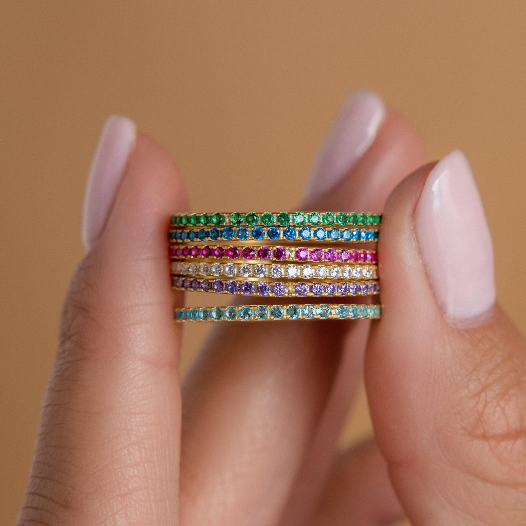 Birthstone eternity ring with colorful gemstone accents, shown on a clean neutral background