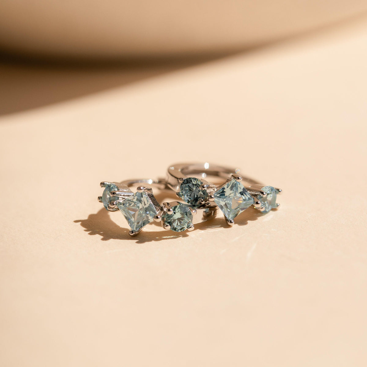 Aquamarine Huggie Hoops by Seven Lucky Gifts • Dainty Blue Crystal Gemstone Earrings • Silver Birthstone Jewelry • Bridesmaid Gift